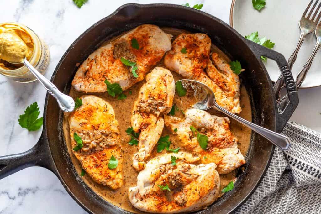 Mustard chicken in a skillet, pictured from above