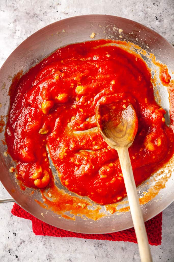 Tomato passata added to the pan of aromatics