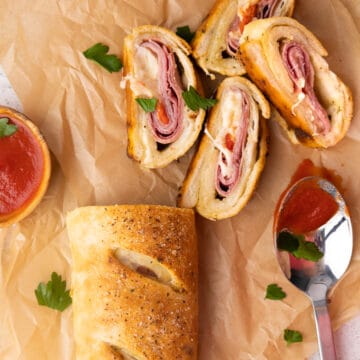 Cold cut stromboli sliced with tomato sauce