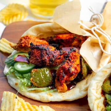chicken tikka in a naan wrap, with chips on the side