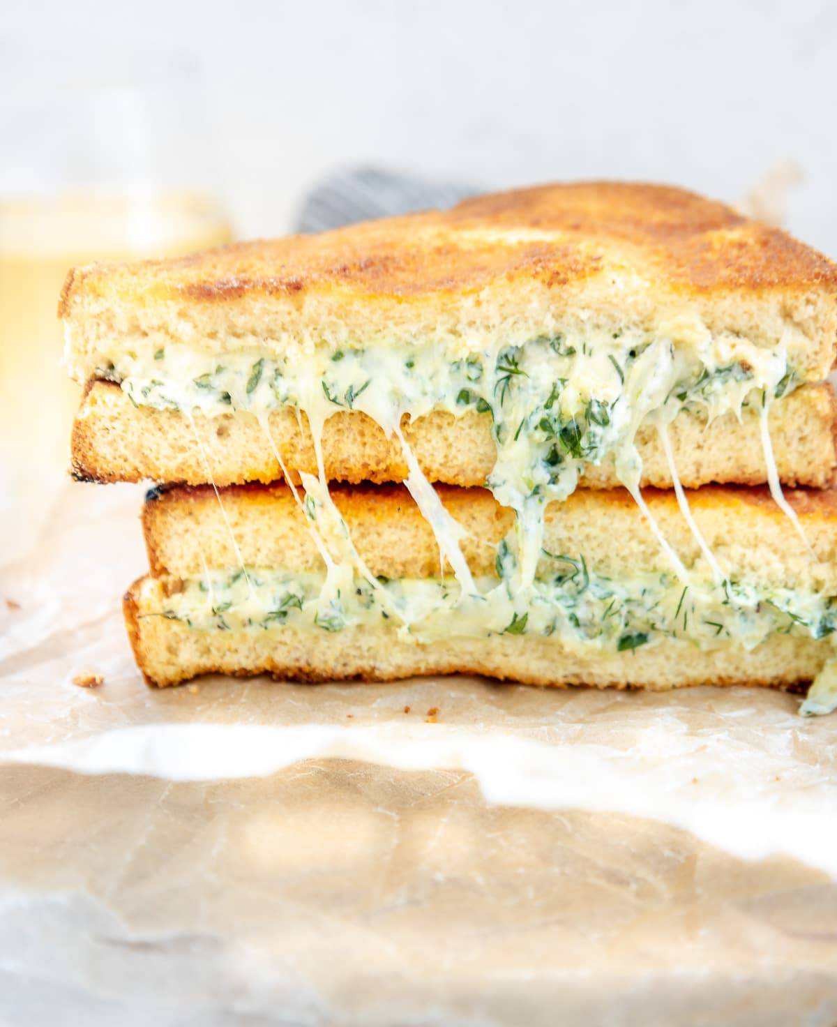Greek spanakopita grilled cheese cut in half with cheese filling shown