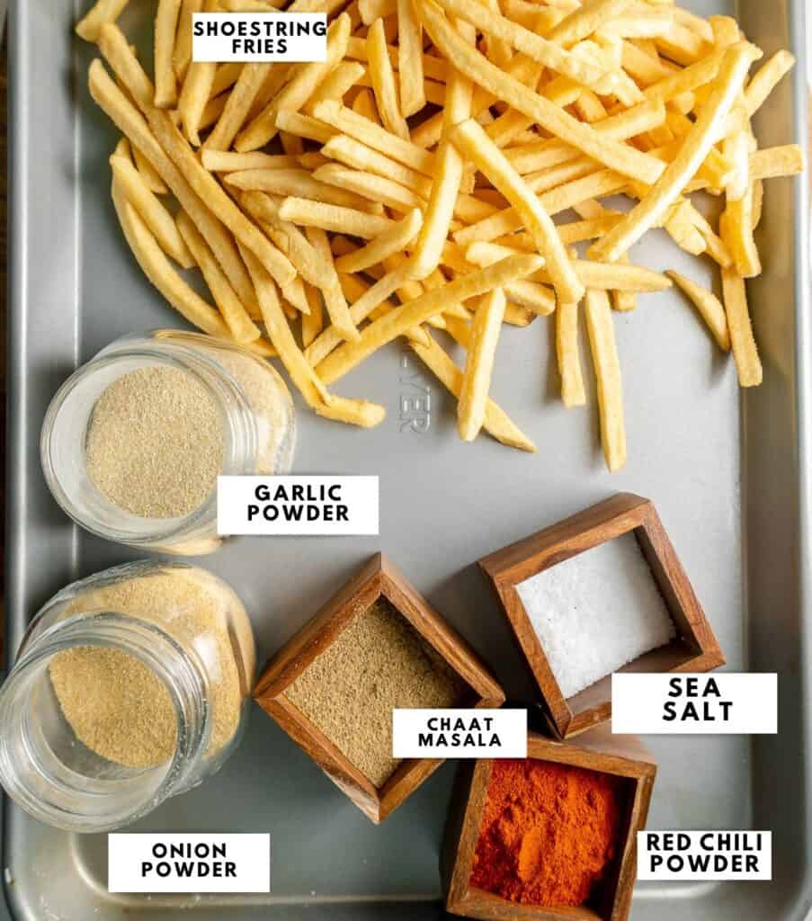 Ingredients to make masala fries, labelled on a sheet tray.