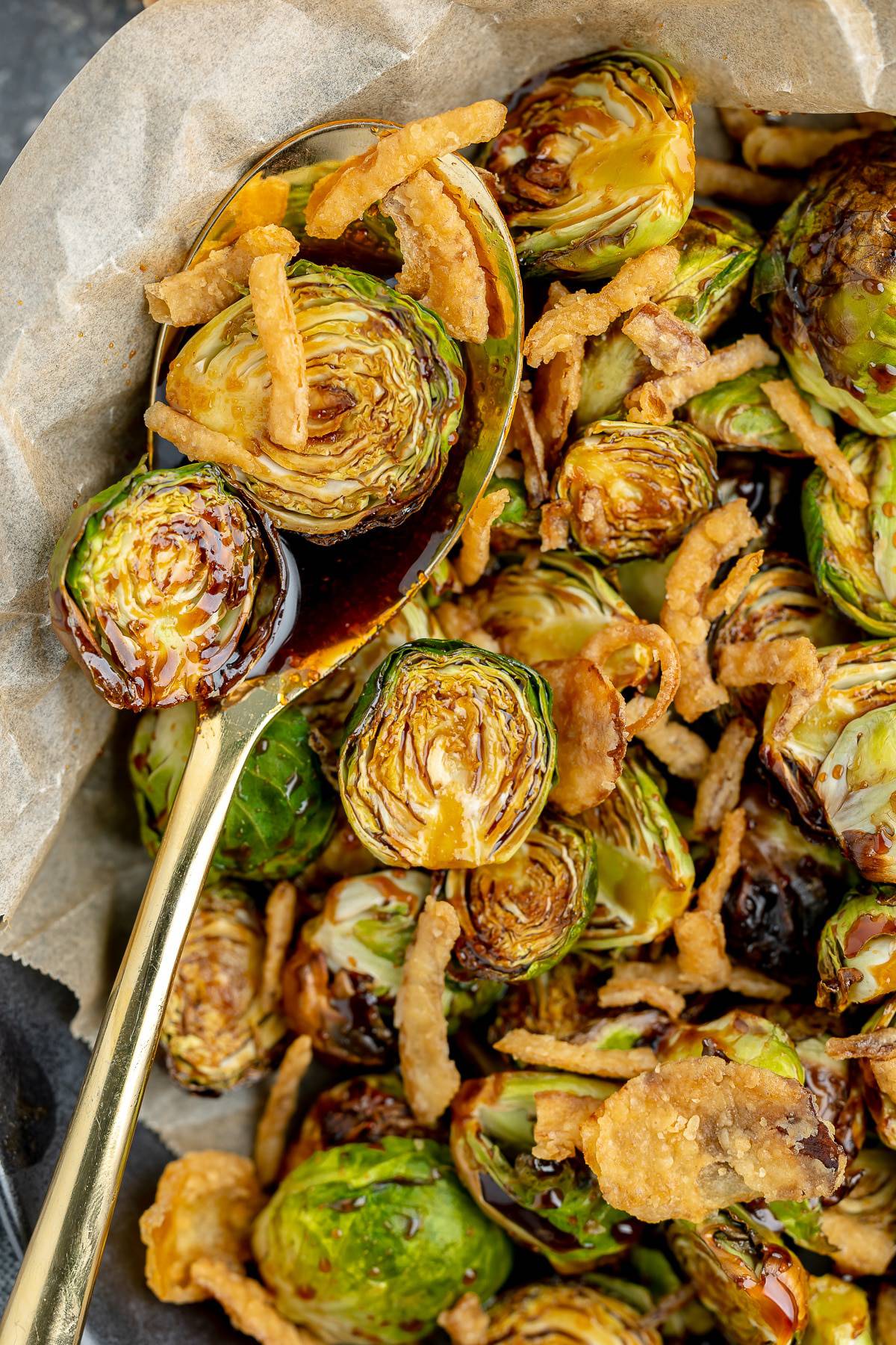 Red lobster brussel sprouts with soy glaze on a spoon.