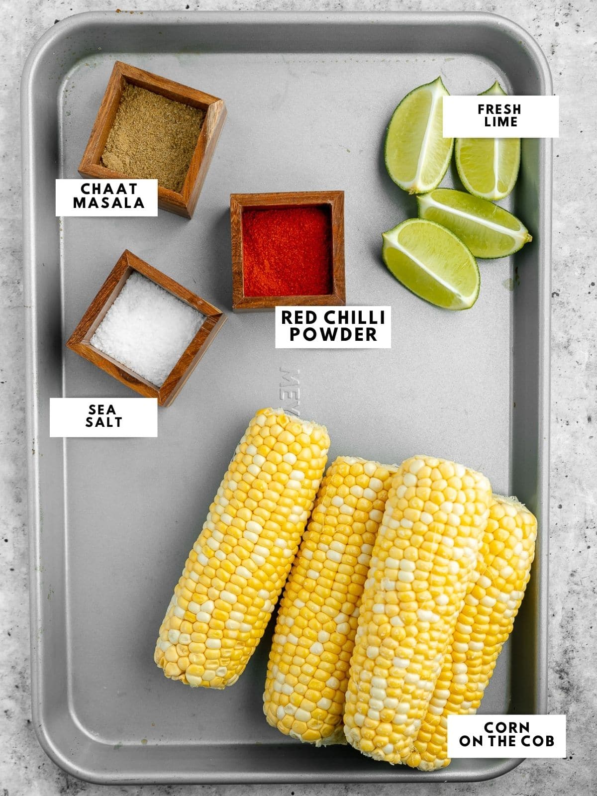 Ingredients for Indian street corn, labelled on a sheet tray.