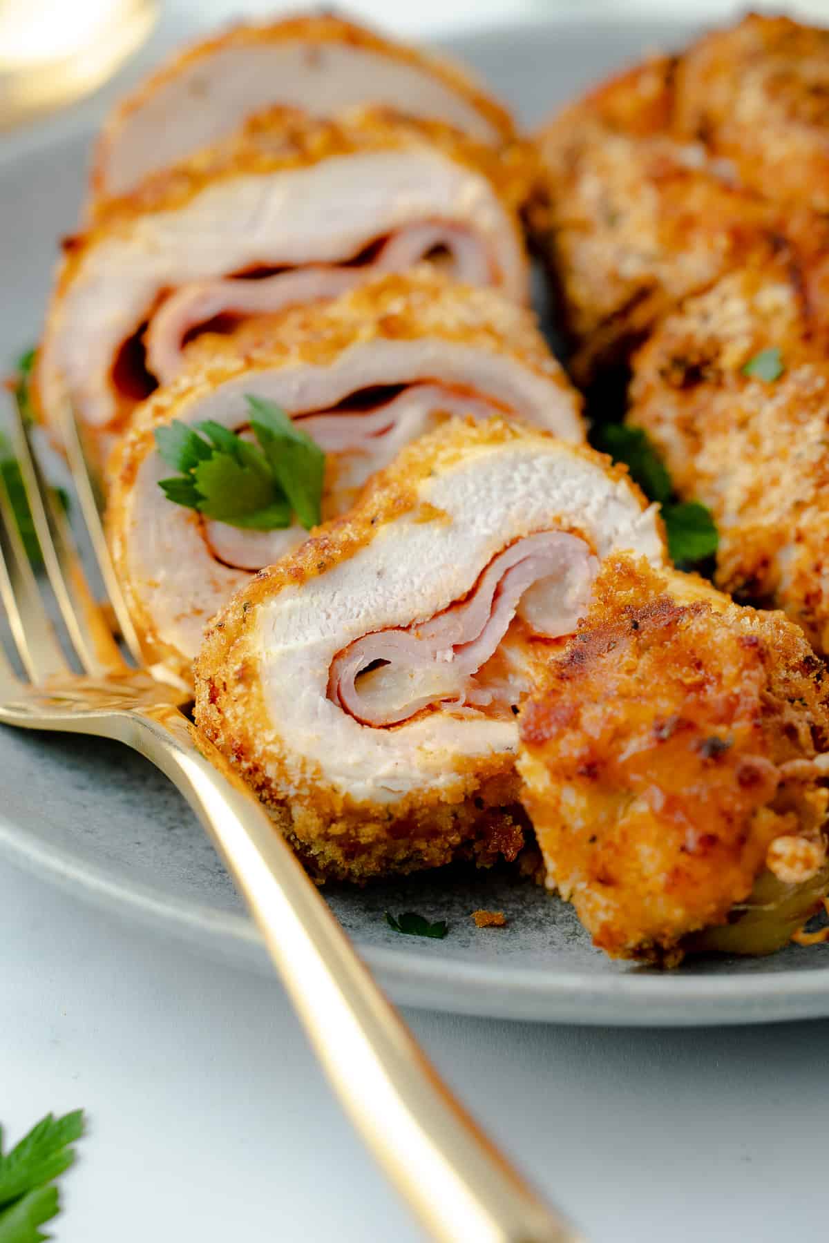 Chicken cordon bleu sliced and served on a plate. 