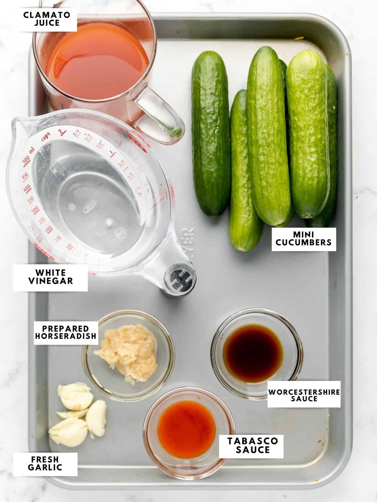 Ingredients for bloody mary pickles, labelled on a sheet tray.