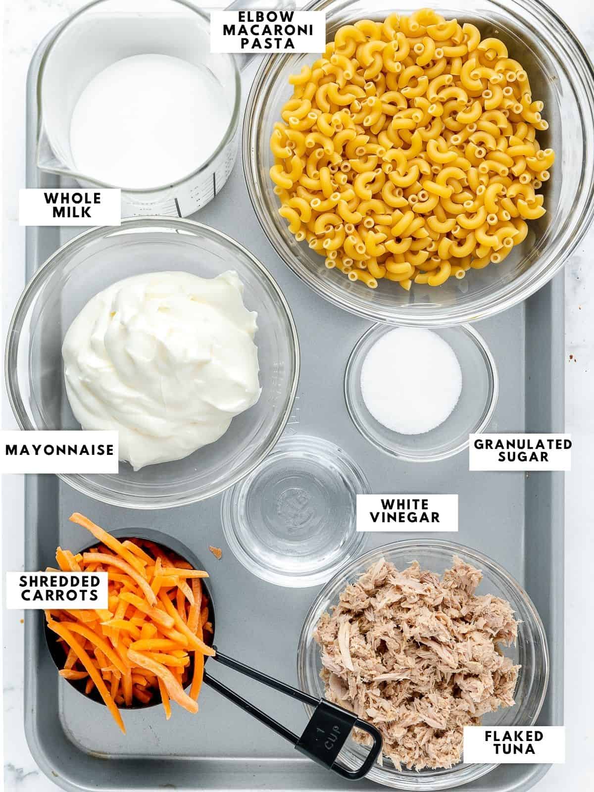 Ingredients for tuna mac salad labelled on a sheet tray.