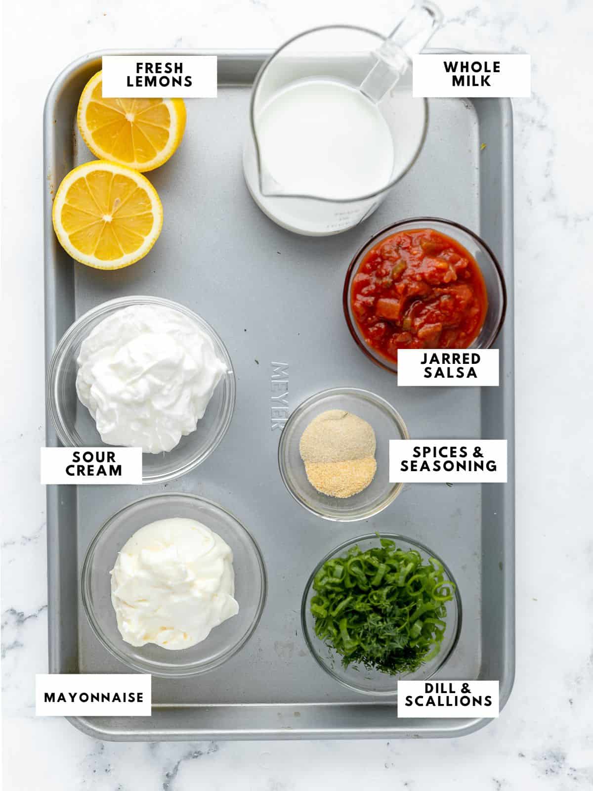 ingredients for salsa ranch dressing labelled on a sheet tray.
