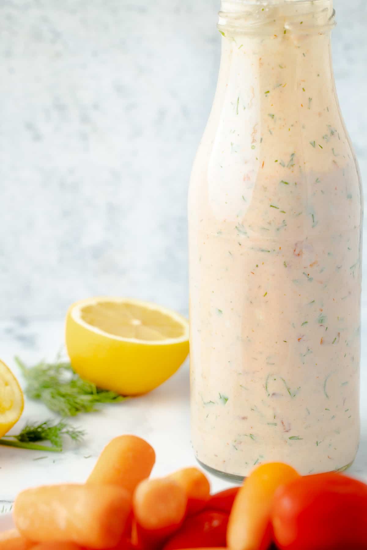 Salsa ranch dressing in a bottle, served with vegetables.