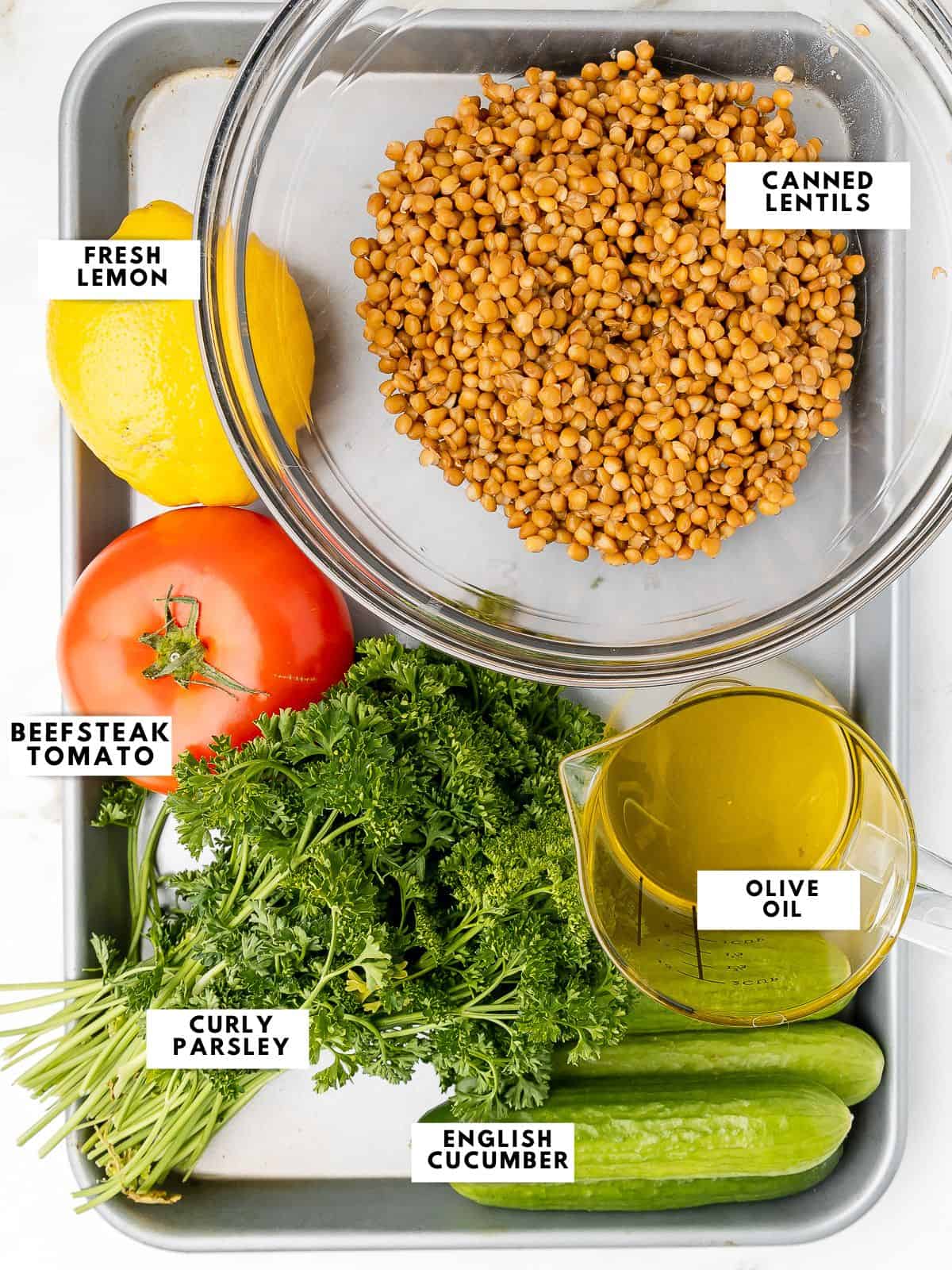 Ingredients for cava lentil tabbouleh labelled on a sheet tray. 