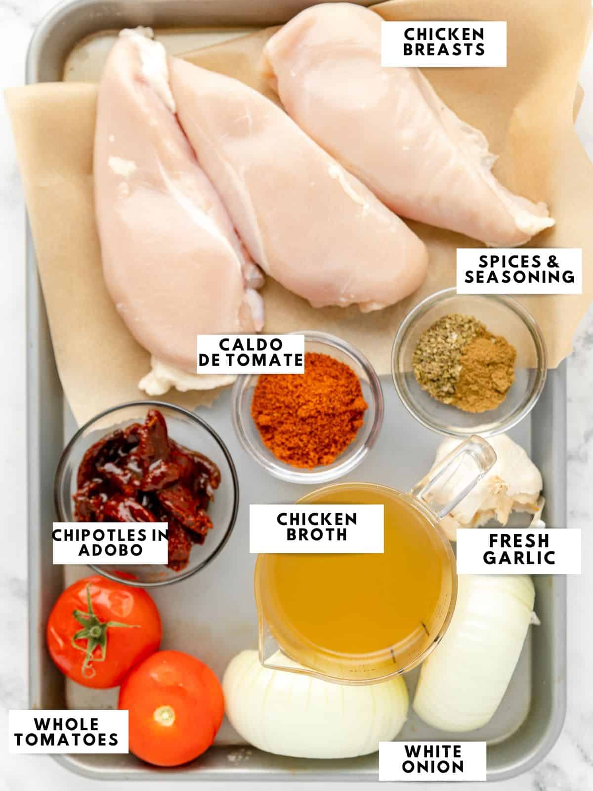 Ingredients for chicken tinga labelled on a sheet tray.
