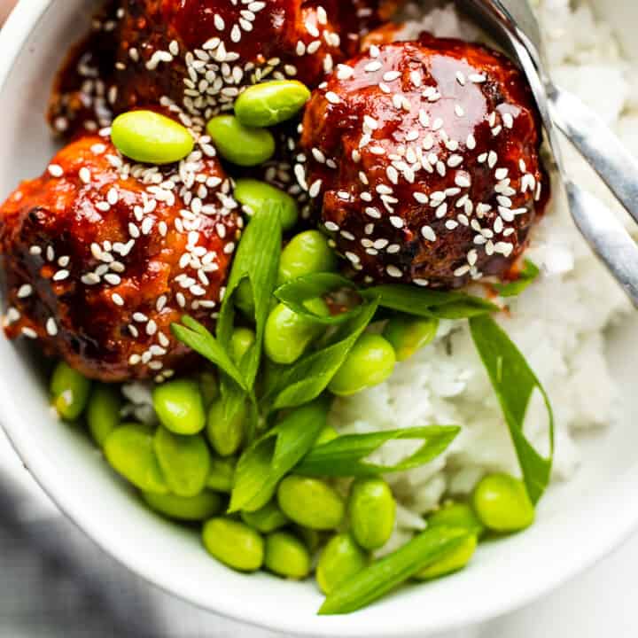 Flat lay photo of a bowl with Korean Glazed Chicken Meatballs with rice, and topped with edamame