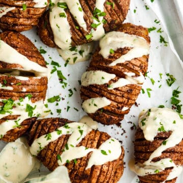 A sheet tray lined with parchment with the Air Fryer Hasselback Potatoes in it