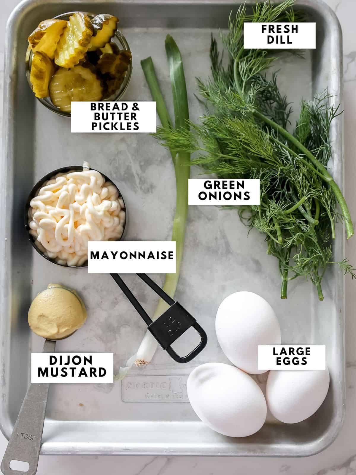 Recipe ingredients labelled on a sheet tray.