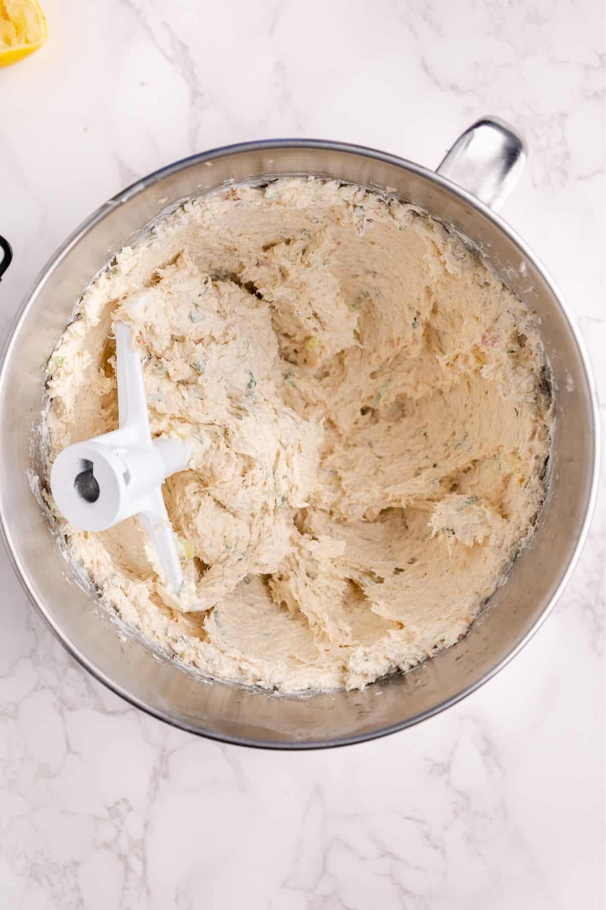 Crab and cream cheese filling whipped in a stand mixer bowl.