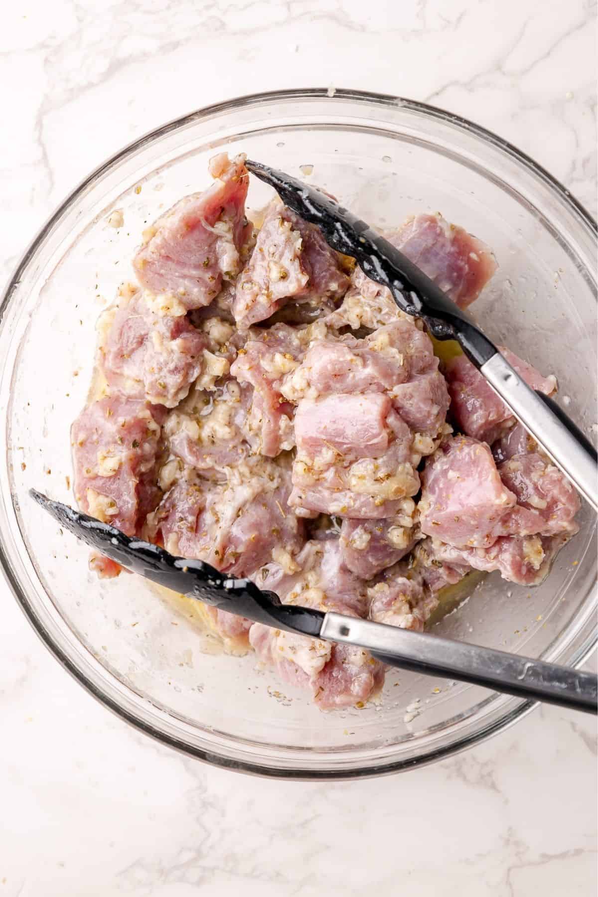 Marinated pork in a mixing bowl. 