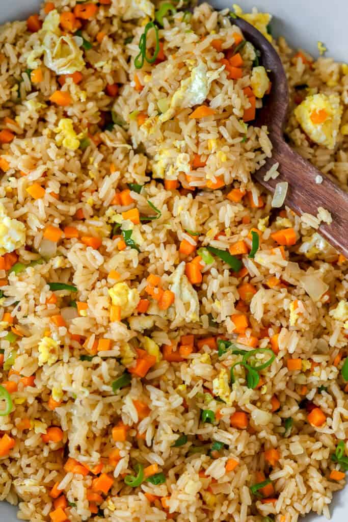 Benihana fried rice in a large serving bowl, with a serving spoon.
