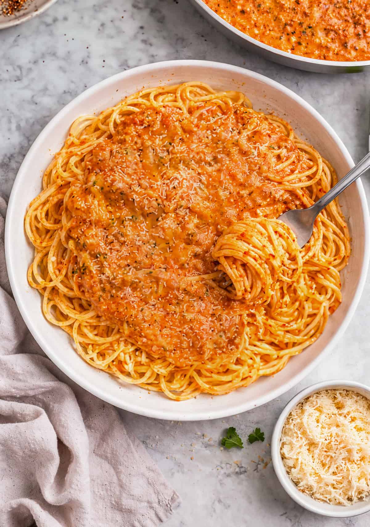 Five cheese marinara sauce served on spaghetti, in a bowl.