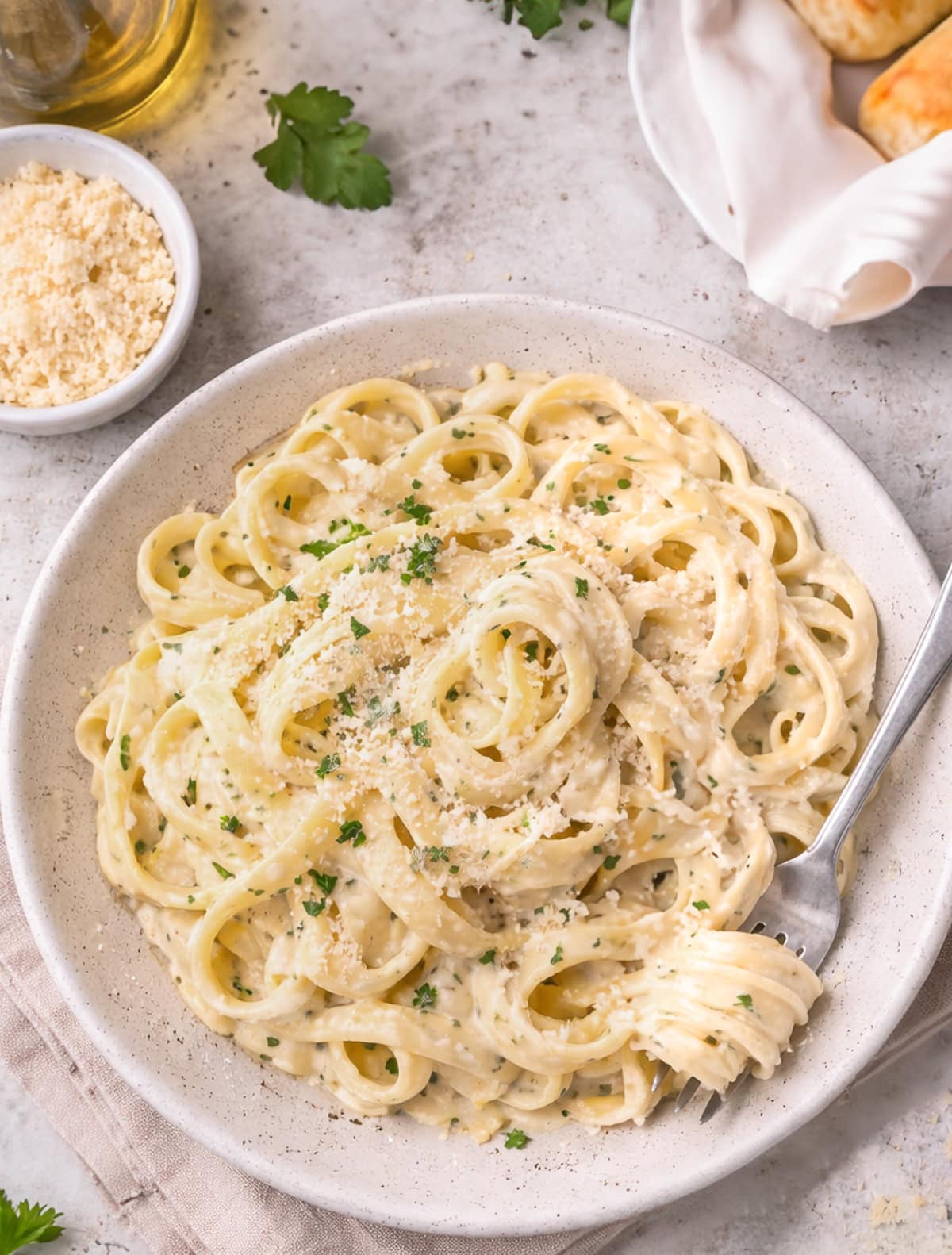 Olive Garden Alfredo Pasta in a bowl, with a fork twirling pasta.